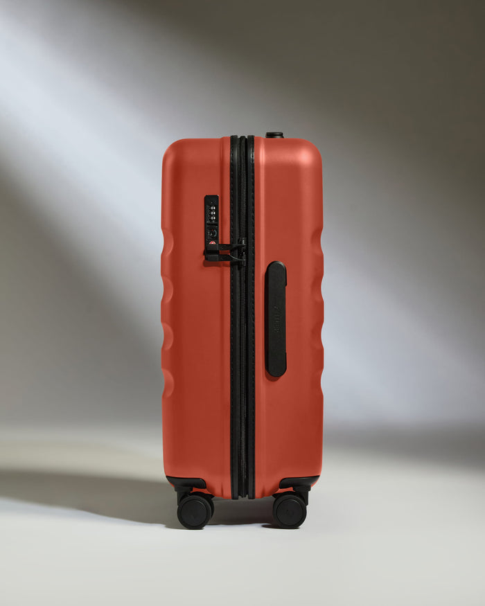 a red suitcase with wheels