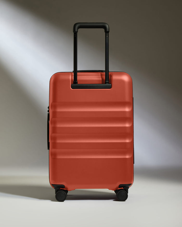 a red suitcase with black wheels