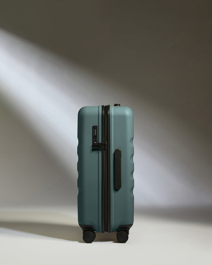a suitcase with wheels and light shining on it