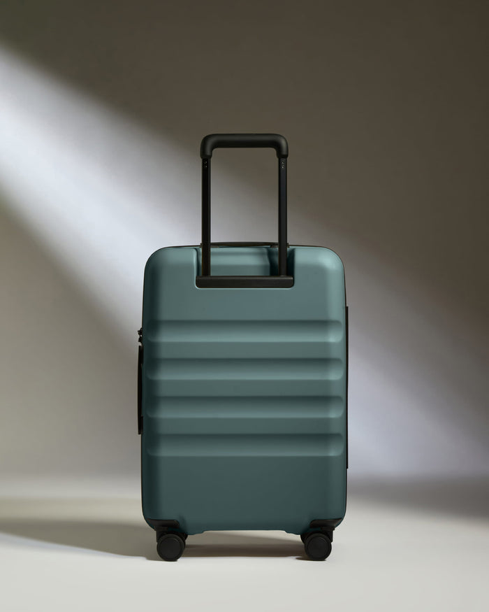 a blue suitcase with black handle