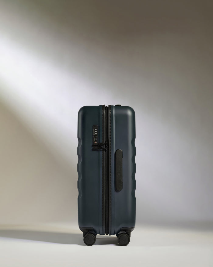 a suitcase on wheels with light shining on it