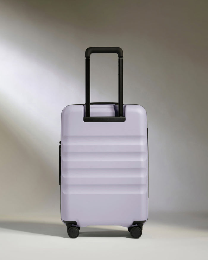 a purple suitcase with black handles