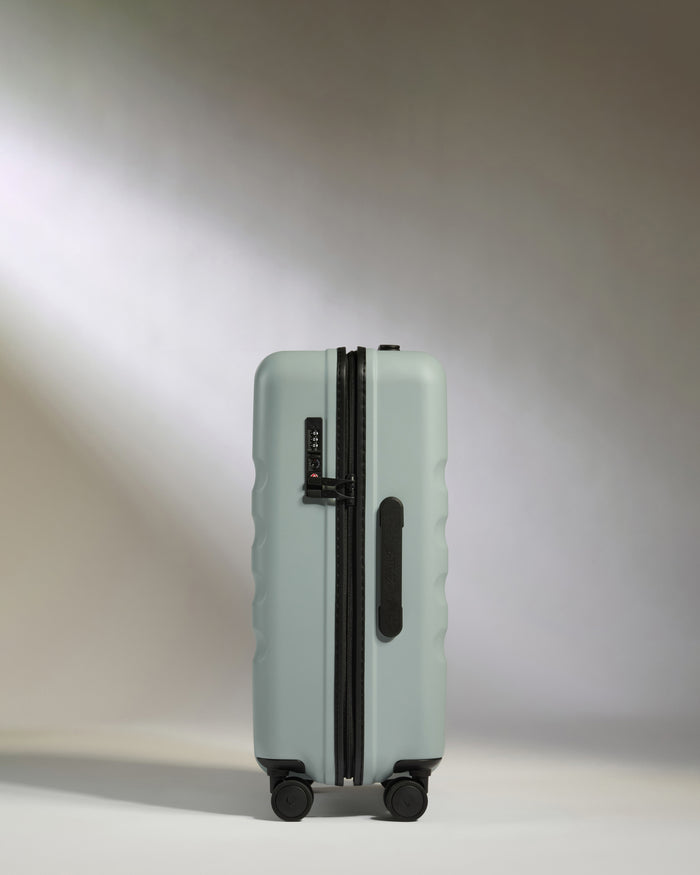 a suitcase on wheels with light shining on it