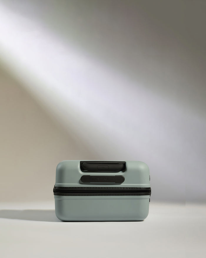 a small grey suitcase with black handles