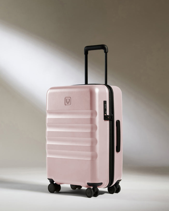 a pink suitcase with wheels