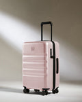 a pink suitcase with wheels