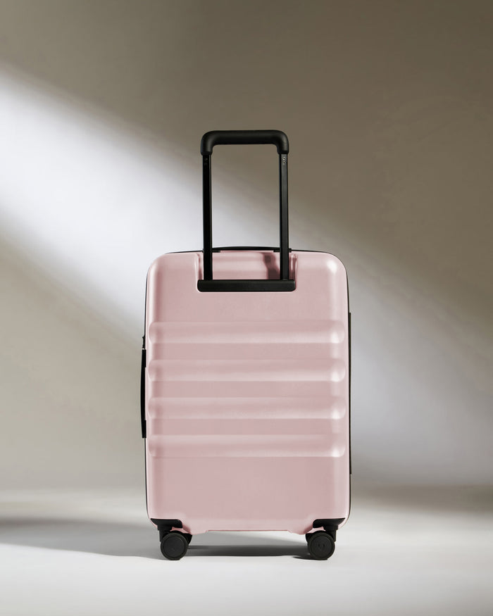a pink suitcase with wheels