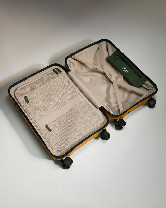 a suitcase with wheels and a green wallet