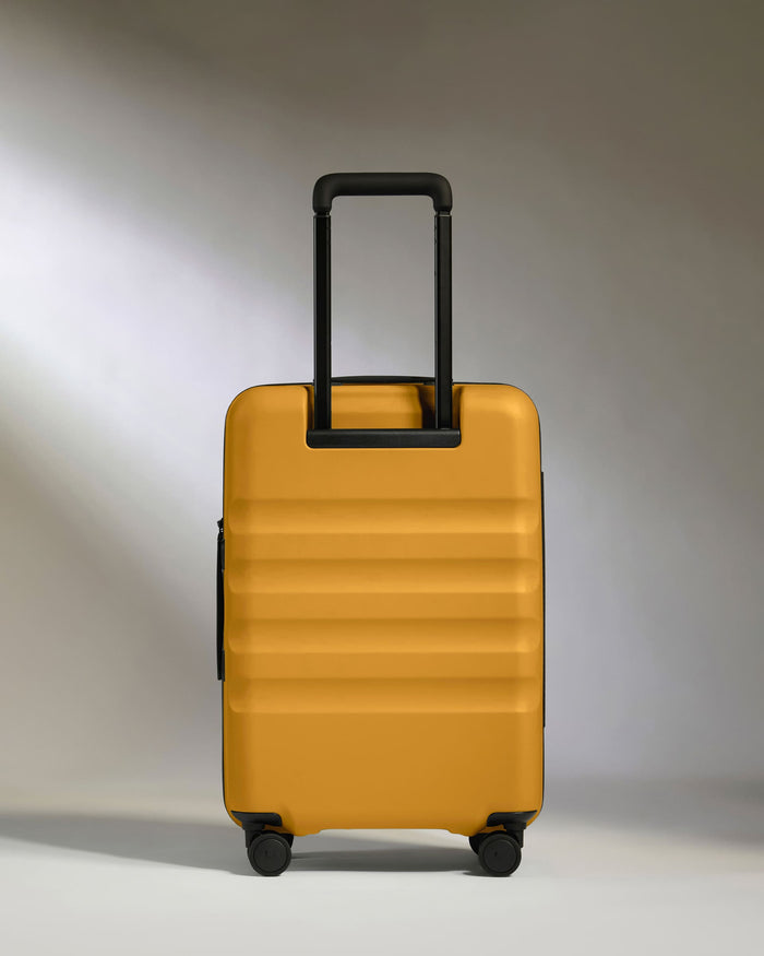 a yellow suitcase with black handles