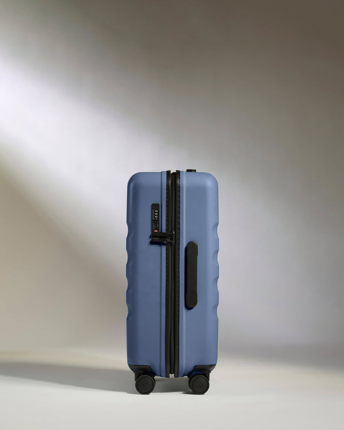 a blue suitcase with wheels