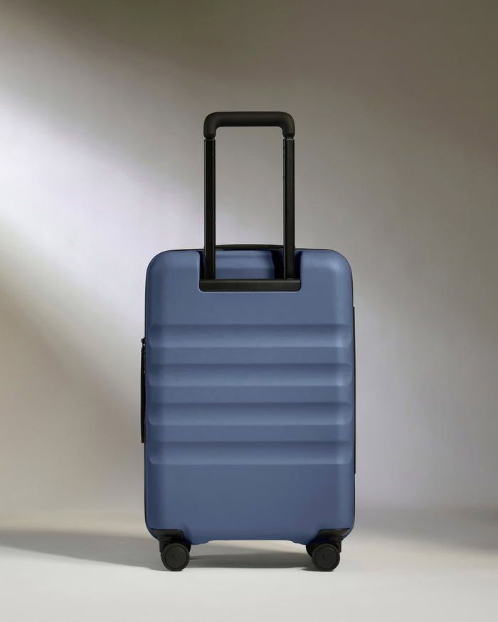 a blue suitcase with black handle
