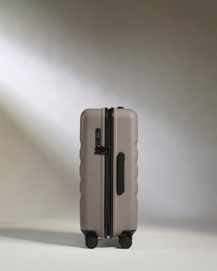 a grey suitcase with wheels