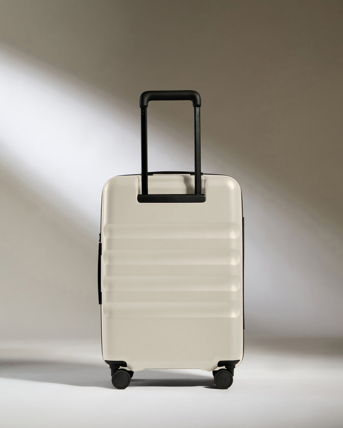 a white suitcase with black wheels