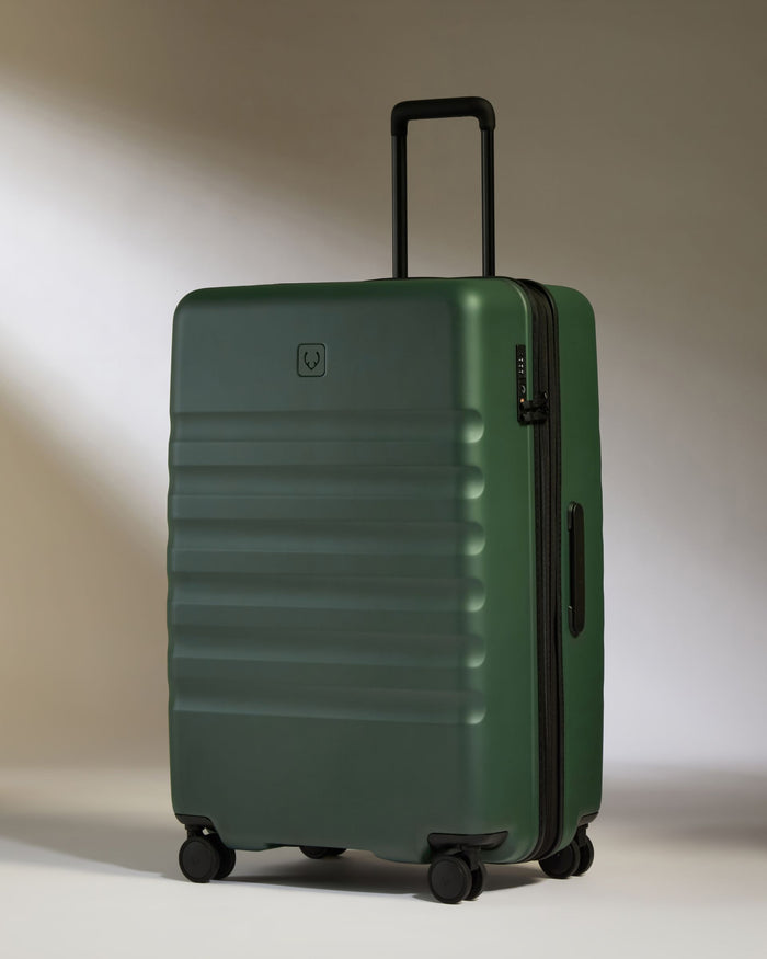 a green suitcase with wheels