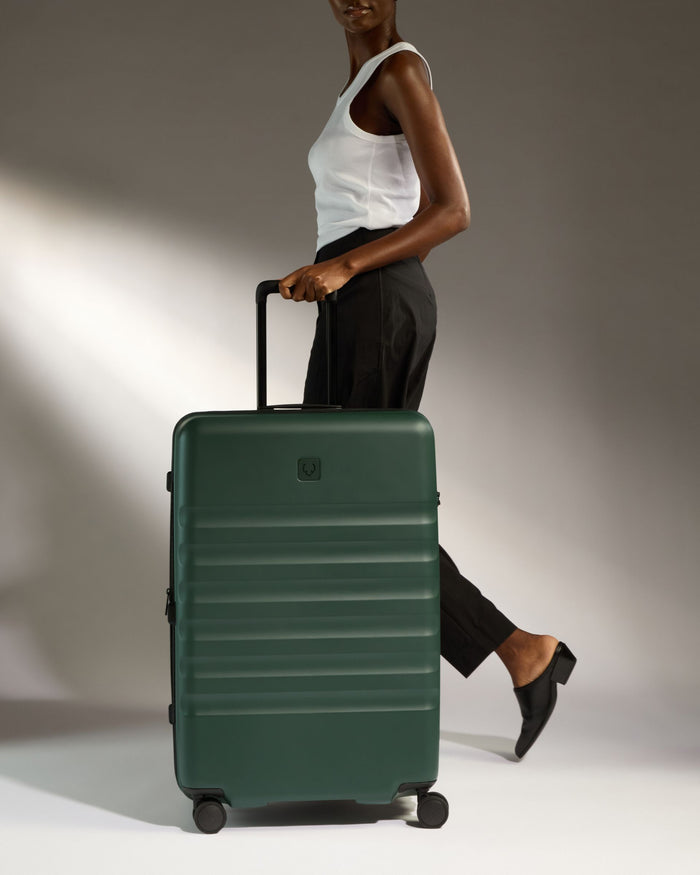 a woman walking with a suitcase