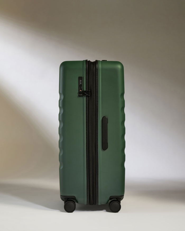 a green suitcase with wheels