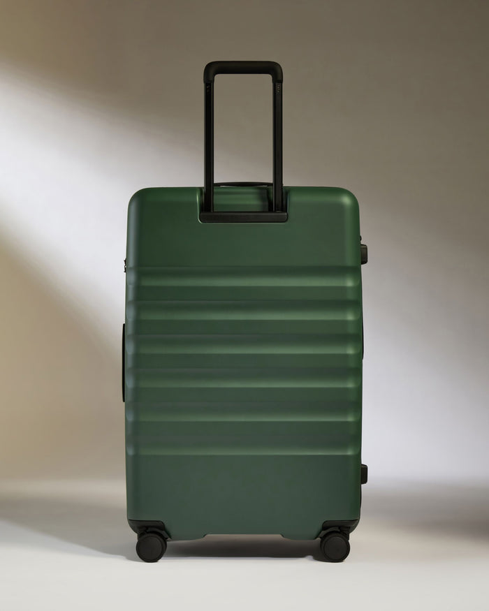 a green suitcase with a handle