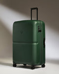 a green suitcase with wheels