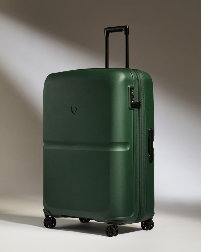 a green suitcase with wheels
