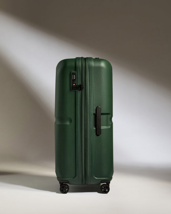 a green suitcase with wheels