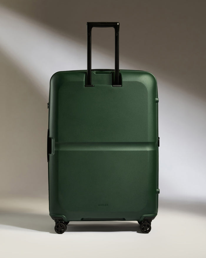 a green suitcase with wheels