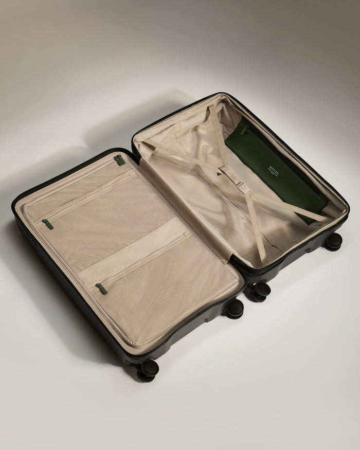 a suitcase with wheels and a green cover