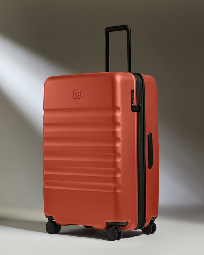 a red suitcase with wheels