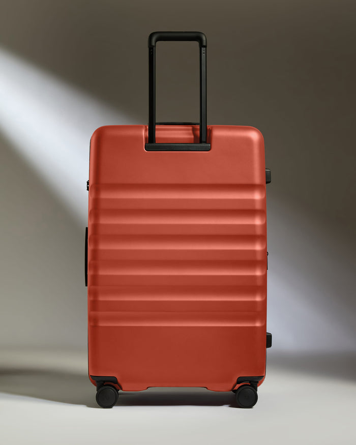 a red suitcase with black handles