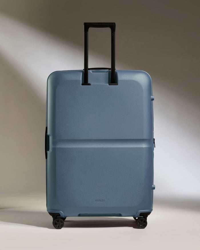 a blue suitcase with black handles