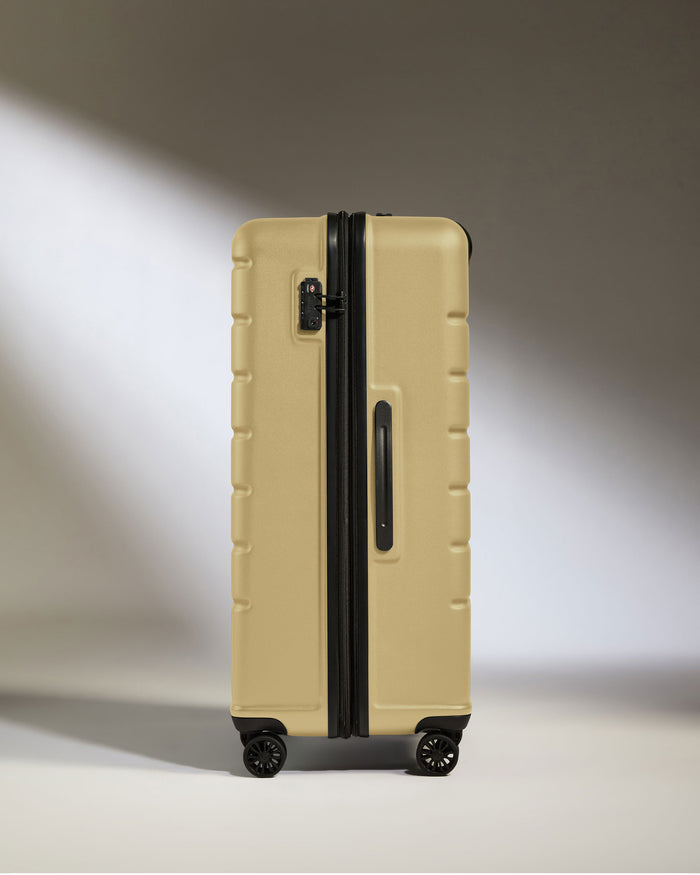 a tan suitcase with wheels