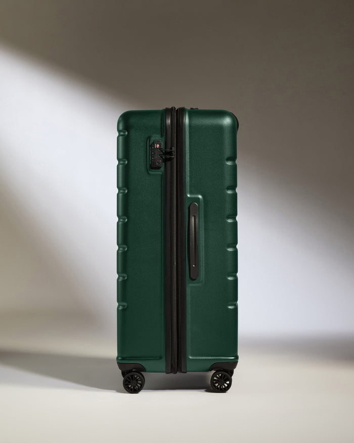 a green suitcase with wheels