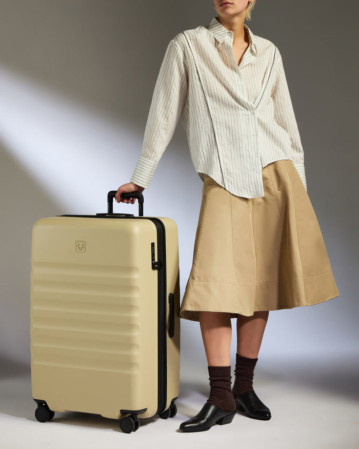a woman standing next to a suitcase