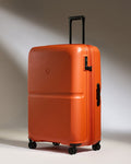 an orange suitcase with wheels