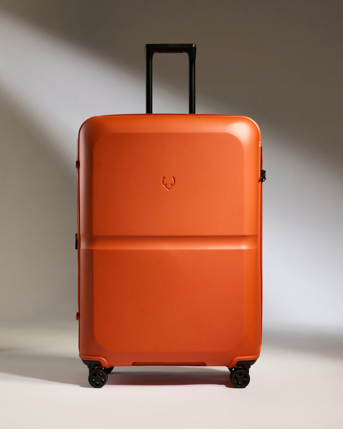 an orange suitcase with wheels