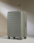 a grey suitcase with wheels