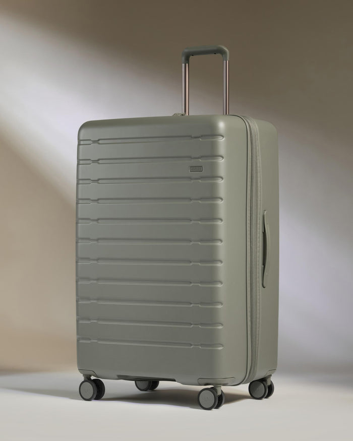a grey suitcase with wheels