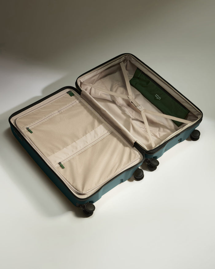 a suitcase with wheels and a green cover