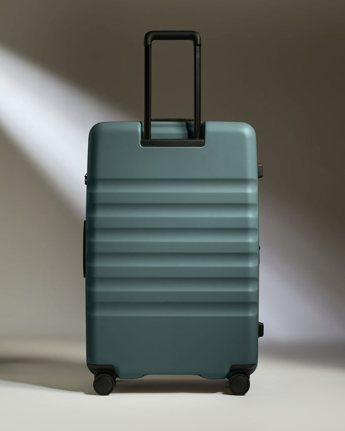 a blue suitcase with black handles