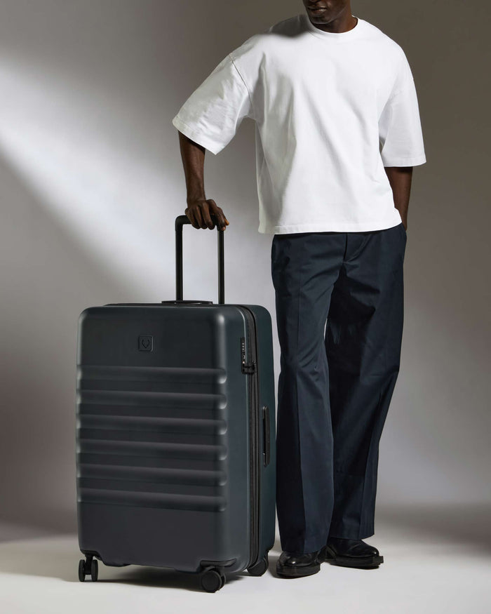 a man standing with a suitcase