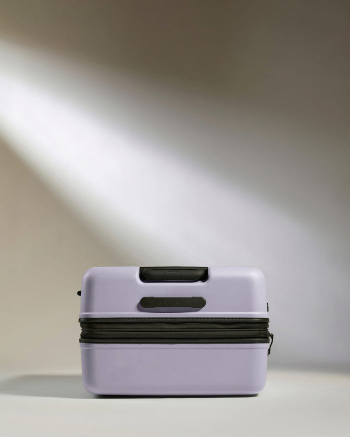 a purple suitcase with a black zipper