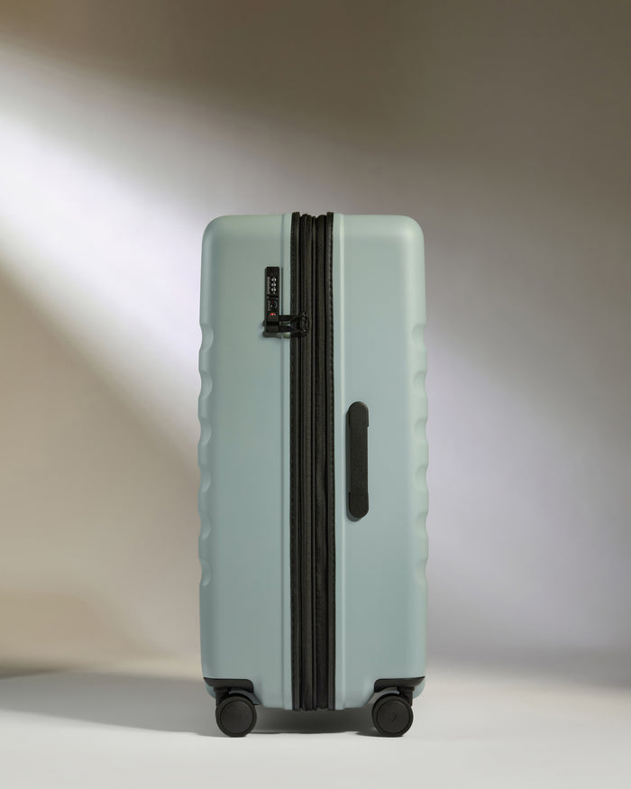 a suitcase with wheels on a white surface