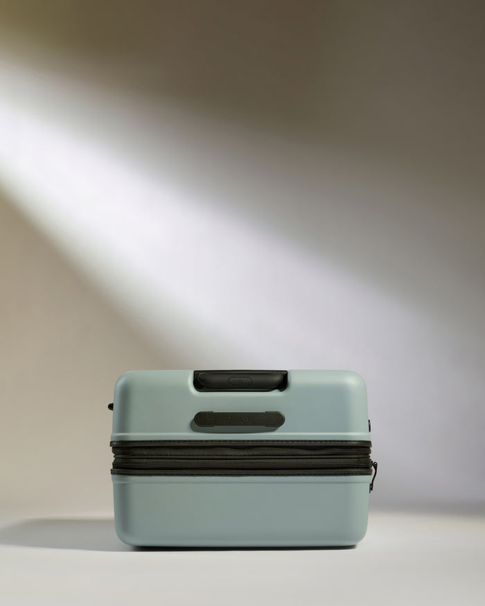 a light shining through a blue suitcase