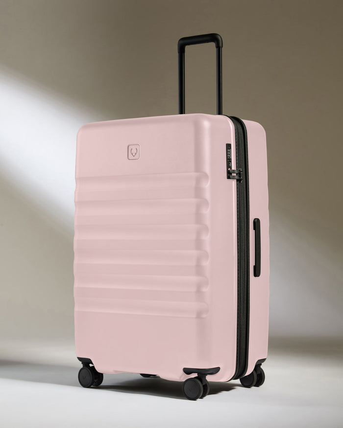 a pink suitcase with wheels