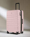 a pink suitcase with wheels