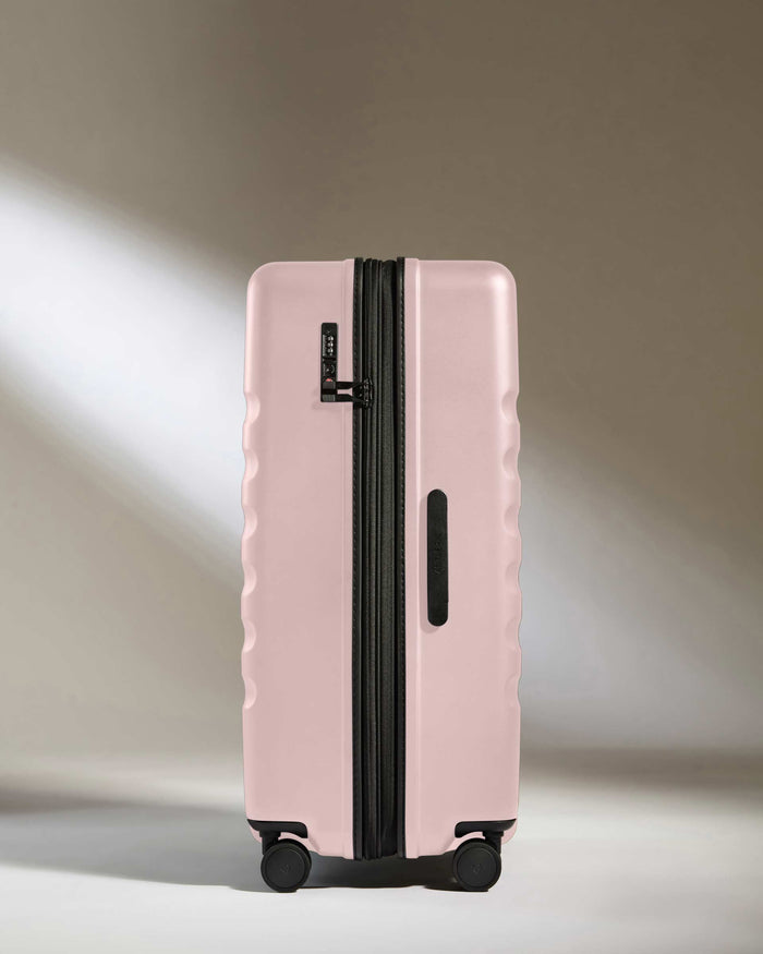 a pink suitcase with wheels