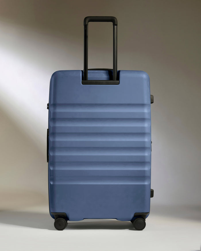 a blue suitcase with black handles