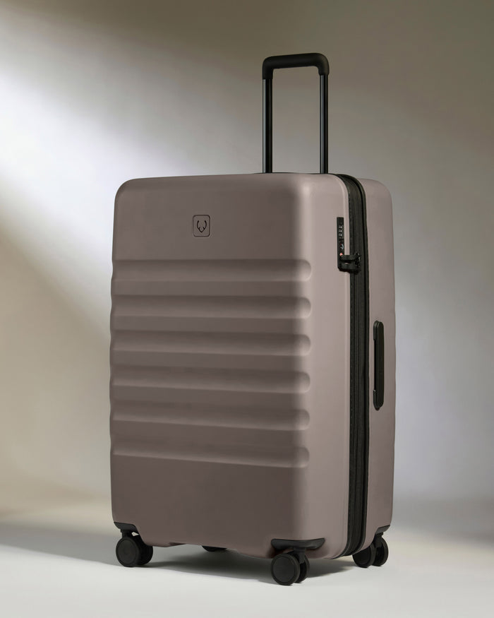 a grey suitcase with wheels