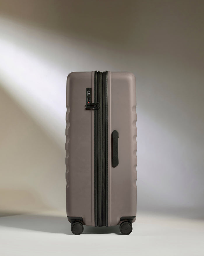 a grey suitcase with wheels