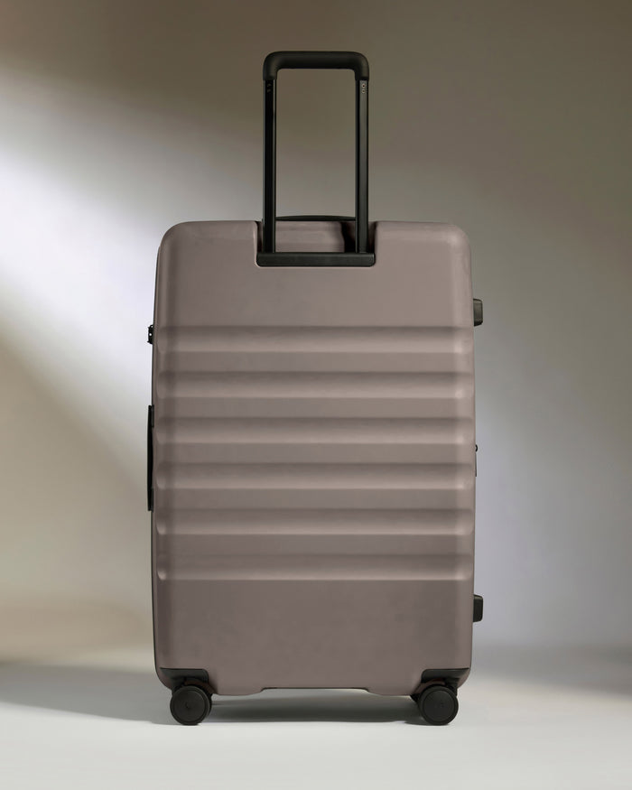 a grey suitcase with black handles