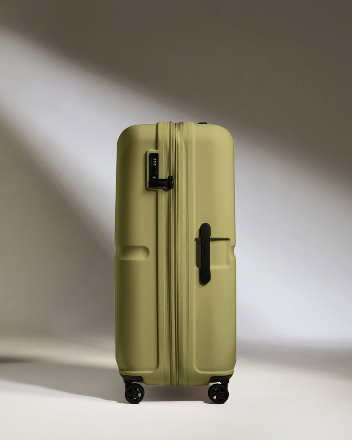 a green suitcase with wheels